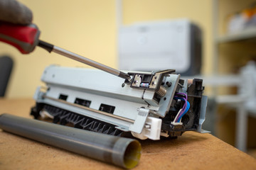 Specialist repairs laser printer. Worn and torn thermal film. Faulty thermal node