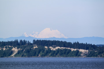 The snow capped mountain of Mt. Rainer in Washington from the water.