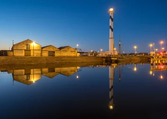 Fototapeten Ostend, Belgium - 2 August 2018: Old lighthouse of Ostend known as ‘Lange Nelle’ at nightfall © Erik_AJV
