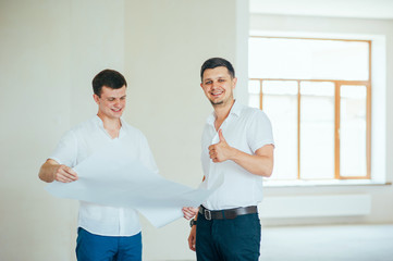 Obraz premium Two business men or engeners working and discussing plane house drawing during the construction and repair process indoor. Architect blueprint Order Customer Industry