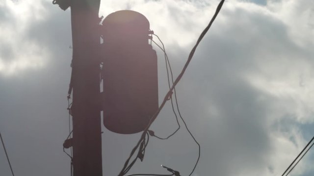 Electric silhouette telephone pole clouds sun light