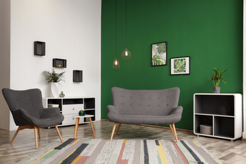 Modern living room interior stylish sofa near green wall