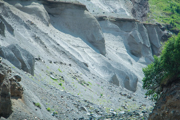 The Caucasus Mountains, high mountains, green meadows and snow-capped mountains.