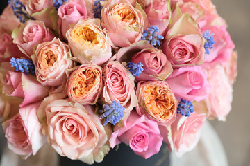 Beautiful arrangement of light pink roses with grape hyacinth in the flowers shop.