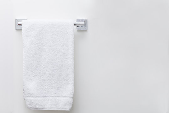 Modern bathroom towel dryer on white wall background with copy space