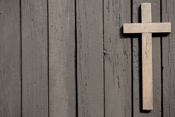 Christian cross on the wooden table 