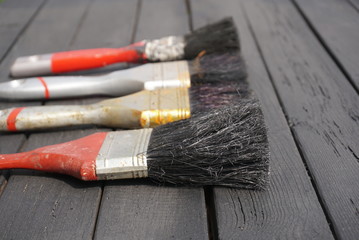 A set of old brushes on a wooden table 
