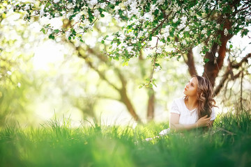 Naklejka na ściany i meble girl spring / portrait of a beautiful girl in a spring blooming park, apple blossoms, beauty, cleanliness, freshness, the smell of spring