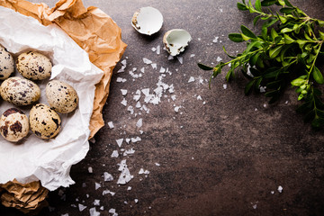 Quail eggs in paper on the kitchen table.