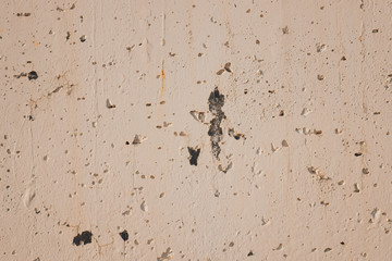 Cracked up beige stone wall, close up