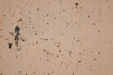 Cracked up beige stone wall, close up