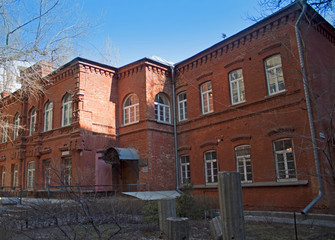 Fototapeta na wymiar Old red brick building in Volgograd, view from the corner at sunny morning.