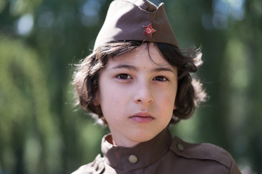 Portrait of a boy in the uniform of a soldier of the Red Army during the Second World War. Face close up.