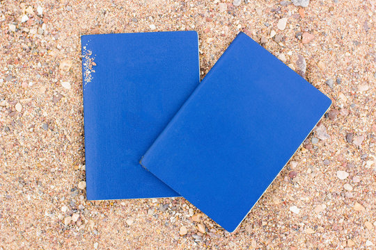 empty blue passport cover documents travel concept pattern picture on a sand beach background texture, copy space for text