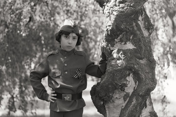 Portrait of a boy in the uniform of a soldier of the Red Army during the Second World War. Black and white.