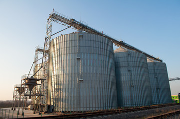 Fototapeta na wymiar Elevators for storage of grain crops, technological industrial granary