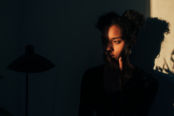 Woman standing near plant with shadow light