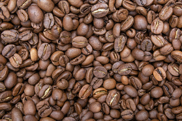 Brown roasted coffee beans, seed on dark background. Aroma, black caffeine drink. Closeup isolated energy mocha, cappuccino ingrediet. Flat lay.