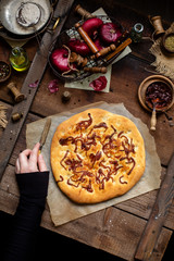Overhead shot of baked homemade focaccia or pizza with caramelized onion