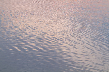  Water abstract background.  Abstract colorful water color, pink and blue  tone.  Sunlight is reflected in the water . For add text .Abstract background photo. Closeup.