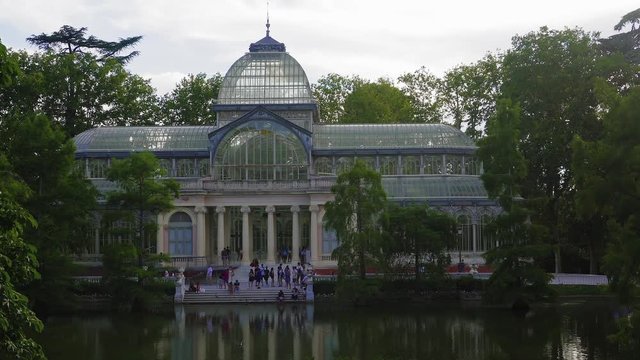 Madrid, Spain Parque de El Retiro Palacio de Cristal external lake view. Evening view of 1887 glasshouse Crystal Palace, before a lake at Buen Retiro Park in the Spanish capital.