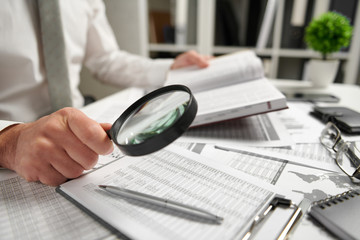 Businessman working at office and calculating finance, reads and writes reports. Business financial...