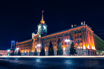 Light car trails in front of Yekaterinburg city center at night © Sergey Egorov
