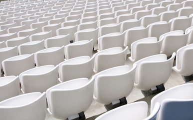 Fototapeta premium rows of empty white seats in the sports stadium