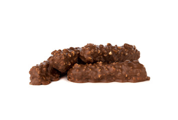 Chocolate bar on a white background. Candy with peanuts and raisins, caramel, puffed rice waffles, in chocolate isolated on white background.