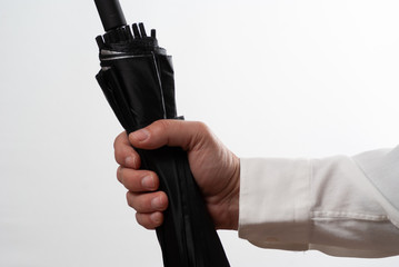 Man holding closed umbrella