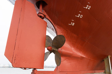 a rusty red fishing boat propeller in dock © aigarsr