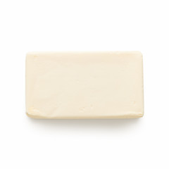 Block of butter on white