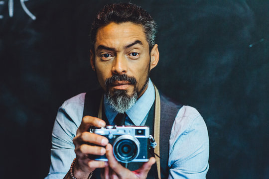 Portrait of a male photographer holding his camera