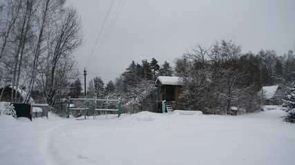 Village yard in the winter in the snow.