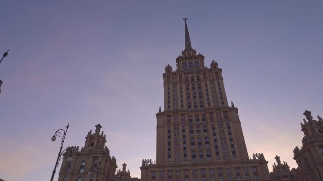One of the seven Stalin skyscrapers. Beautiful old building in Moscow. Spire with a star on the roof. Smooth approach to the building, and smooth distance from it. Daytime. Ultra HD stock footage