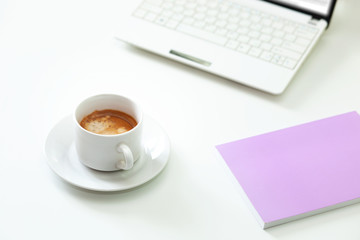 Coffee cup , laptop and lavender notpad on white table. Selective focus.