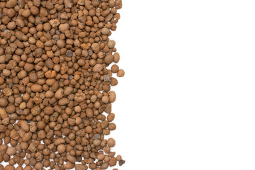 Lot of whole brown clay pebbles (leca) copyspace flatlay isolated on white background