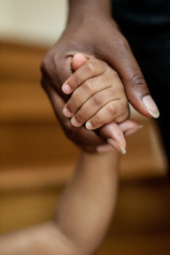 Close up of mother holding daughter's hand