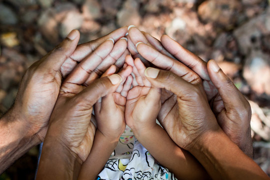 Close up of family with cupped hands