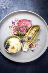 Barbecue wagyu point steak from beef sliced with chicory and mashed potatoes as top view on a modern design plate