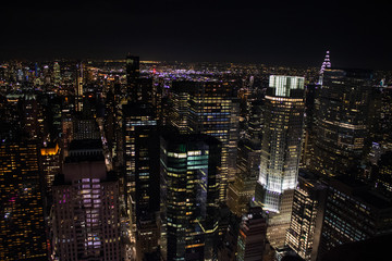 Obraz na płótnie Canvas Night time aerial view of Manhattan in New York City showing the classic high rise buildings and city scape in the USA