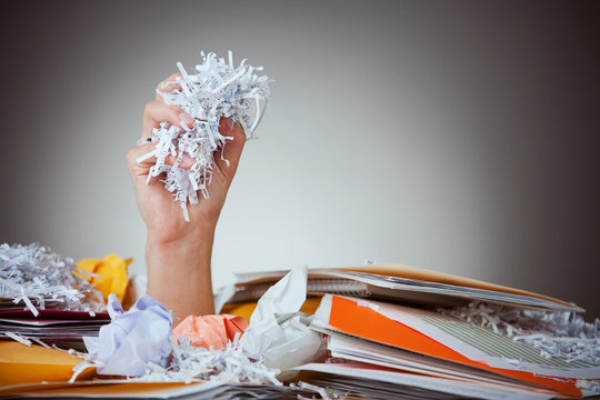 Business: Man Holding Handfull of Shredded Paper