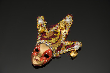 miniature Carnival mask on black