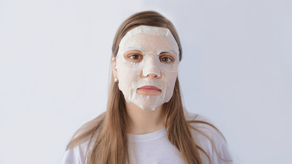 beautiful and cute girl in mask, skin care and moisturizing, with lemon, white background