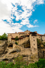 Fototapeta premium The Great Meteoron Monastery, in the complex of Meteora, Greece. Entrance area. Touristic destination. Beautiful blue sky with clouds in the background