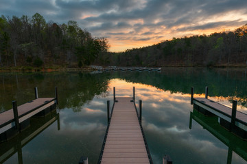 docks on lake during sunrise with reflection