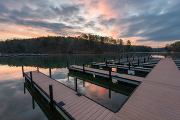 dock on lake during colorful sunrise