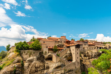 The Great Meteoron Monastery, in the complex of Meteora, Greece. Entrance area. Touristic destination. Beautiful blue sky with clouds in the background
