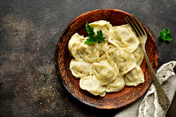 Traditional russian dish pelmeni - dumplings stuffed with minced meat.Top view with copy space.