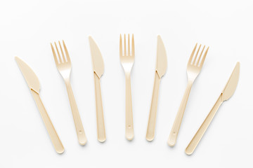 Plastic flatware for eco and Earth protection concept on white background top view